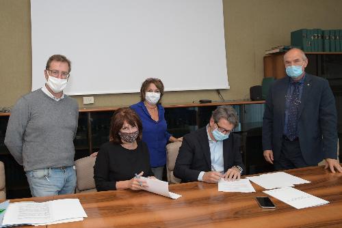 L'assessore al Lavoro Alessia Rosolen firma il protocollo. Alla sua destra il vice sindaco del Comune di Trieste Paolo Polidori, mentre alla sua sinistra ci sono la vice presidente del Coselag Sandra Primiceri, il presidente del consiglio di amministrazione Zeno D’Agostino e il sindaco di San Dorligo della Valle-Dolina Sandy Klun.